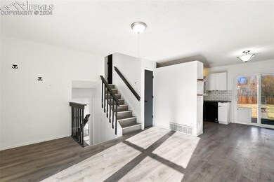 Unfurnished living room with dark hardwood / wood-