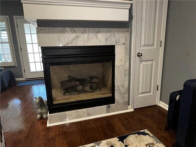 Room details featuring baseboards, a fireplace, an