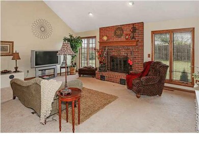 Main floor Living Room with a brick fireplace. Lar
