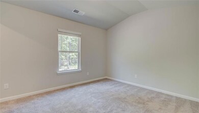 Unfurnished room with light carpet and lofted ceil