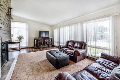 Light and bright living room area with cathedral c