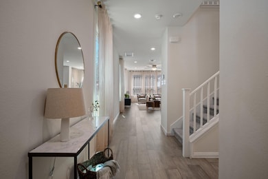 Hall featuring visible vents, baseboards, stairwa