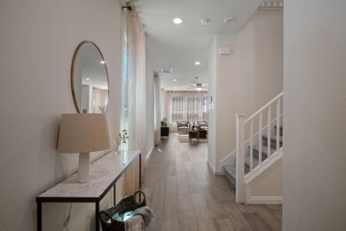 Hall featuring visible vents, baseboards, stairwa