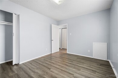 Unfurnished bedroom featuring wood-type flooring and a textured ceiling