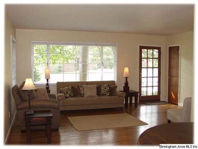 A view of the living area & front door from the di