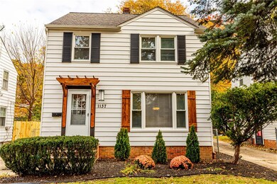 View of front of home featuring a shingled roof and a chimney