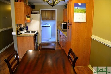 Galley Kitchen features Custom Cabinetry & Granite