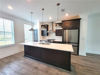 Kitchen featuring light countertops, a sink, stain