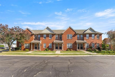 Colonial-style house featuring brick siding