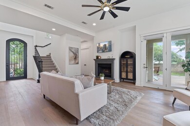 Living room featuring a fireplace with raised hea