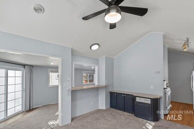 Kitchen with crown molding, ceiling fan, high end white range oven, light countertops, and vaulted ceiling
