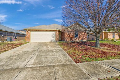 Ranch-style house featuring central AC and a garage
