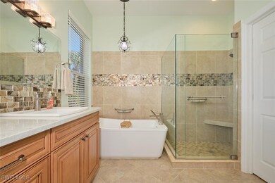 Full bathroom featuring vanity, a freestanding tub