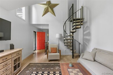 Living room with light hardwood / wood-style flooring and a high ceiling