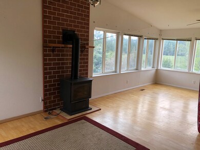 Living Room With Electric Stove & Lots of Windows
