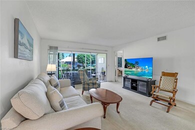 Living room with a textured ceiling and carpet flo