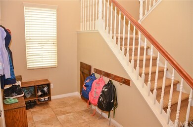 Front entryway with shoe cubbies, coat racks and b