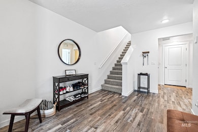 Entrance foyer featuring wood finished floors, stairs, and a textured ceiling