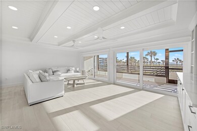 Living room featuring beamed ceiling, ceiling fan,
