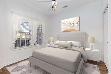 Bedroom with baseboards,  a ceiling fan, dark wood
