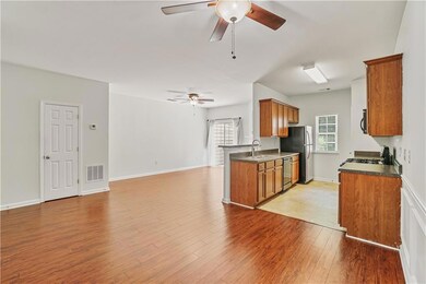 Kitchen with appliances with stainless steel finishes, ceiling fan, and brown cabinetry