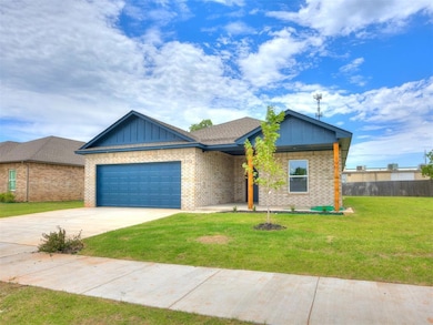 View of front of house with board and batten siding, a garage, brick siding, and driveway