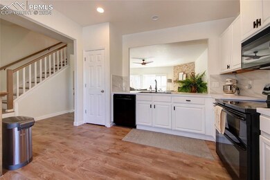 Kitchen with black appliances, ceramic backsplash