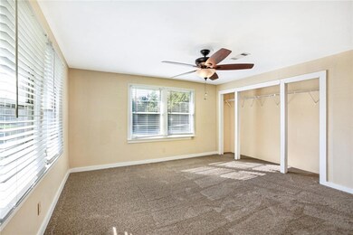 primary bedroom with new carpet and plenty of natu