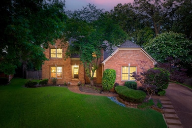 View of front of house featuring brick siding and roof with shingles