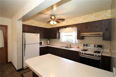 The Open Concept 12x9 Kitchen has a wall of cabine