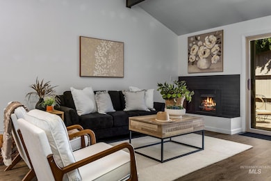 Living area featuring wood finished floors and a brick fireplace
