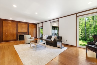 Living room featuring a fireplace, light wood-type