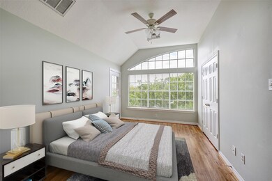The third-floor guest bedroom features wood floors