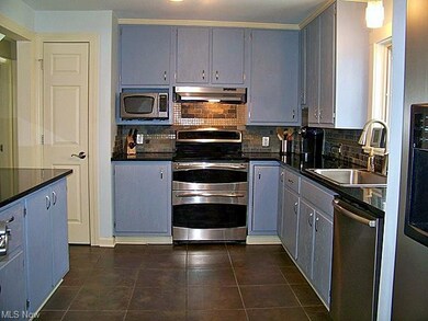 Updated kitchen with wood cabinets, stainless appl