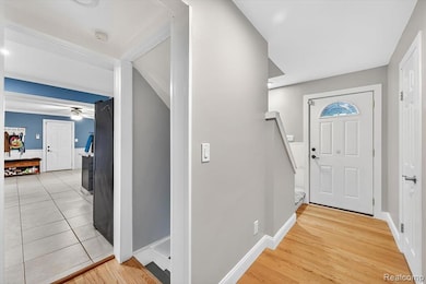 Entryway featuring light wood finished floors and ceiling fan