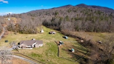 Front aerial view of the home and landscape