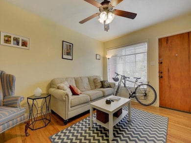 Living area with ceiling fan and wood finished fl