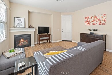 Open floor plan, the living room is light and bright with new flooring, gas fireplace, and large entertaining space.