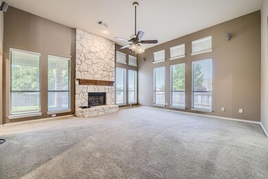 Unfurnished living room with ceiling fan, a stone 