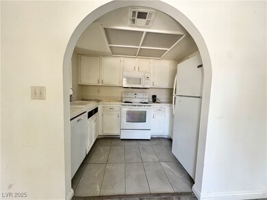 Kitchen featuring white appliances, light tile pat