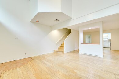 Unfurnished living room with a towering ceiling, 