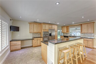 Open Concept kitchen with wood cabinets and granit