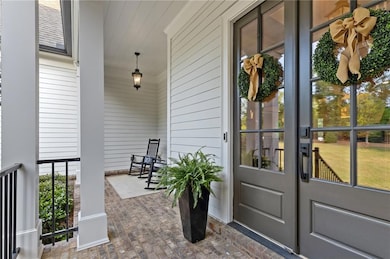 Property entrance featuring a porch and french doors