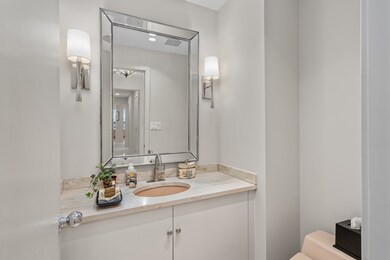 Powder bath off of the entry hall.  Updates include mirror, sconces, faucet, hardware, flooring and paint.