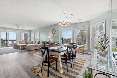 Dining room with ceiling fan with notable chandeli
