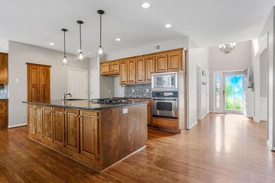 Large island with plenty of storage and new pendant lighting