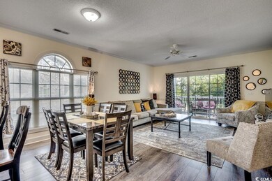 Dining room featuring ceiling fan, wood-type floor