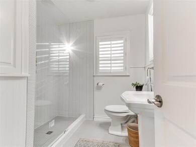 Bathroom with tile patterned flooring and a shower stall
