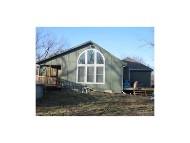 Home from the south showing the covered deck and t