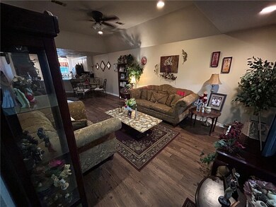 Living area featuring ceiling fan, wood finished f
